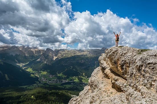 Hiker standing at the top of a hill