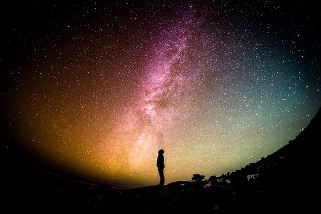 person standing in front of milky way